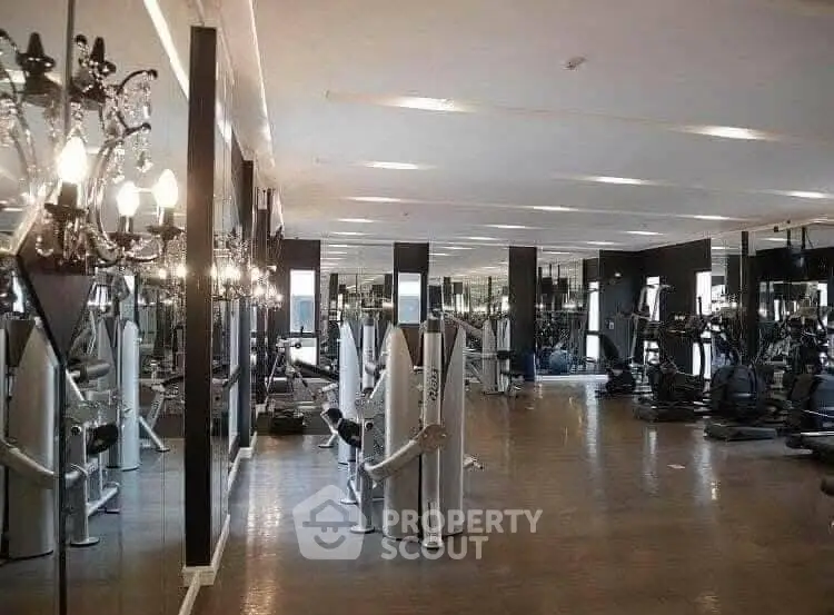 Luxurious gym with modern equipment and mirrored walls in upscale property.
