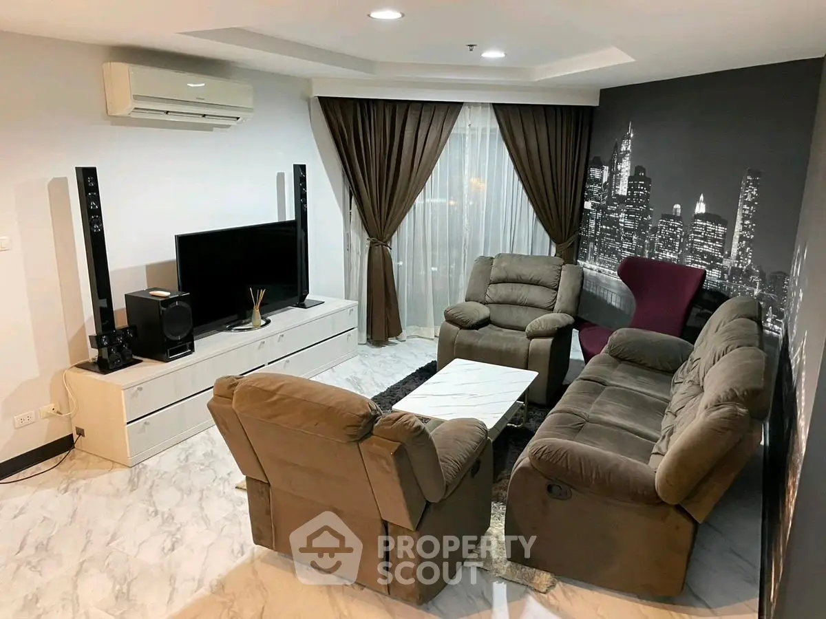 Stylish living room with plush seating and cityscape wall art, perfect for relaxation.