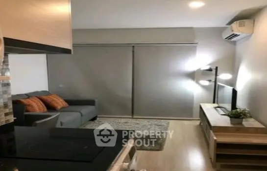 Modern living room with cozy sofa and stylish decor in a contemporary apartment.