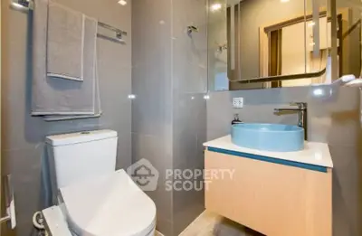 Modern bathroom with sleek fixtures and stylish vanity in contemporary home.