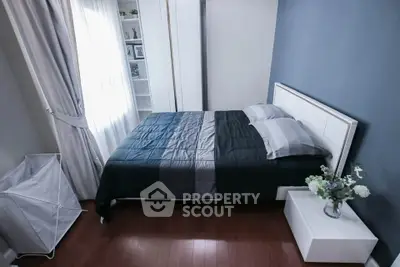 Modern bedroom with stylish decor and natural light, featuring a cozy bed and elegant furnishings.