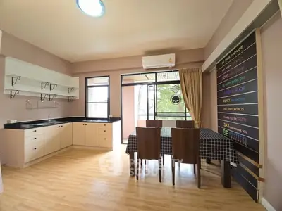 Spacious kitchen with dining area and open layout, featuring modern decor and natural light.