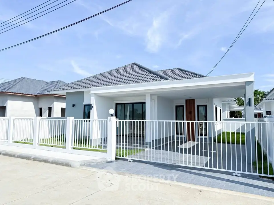 Modern single-story house with sleek design and spacious front yard