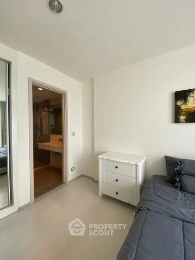 Modern apartment interior with cozy living area and adjacent bathroom