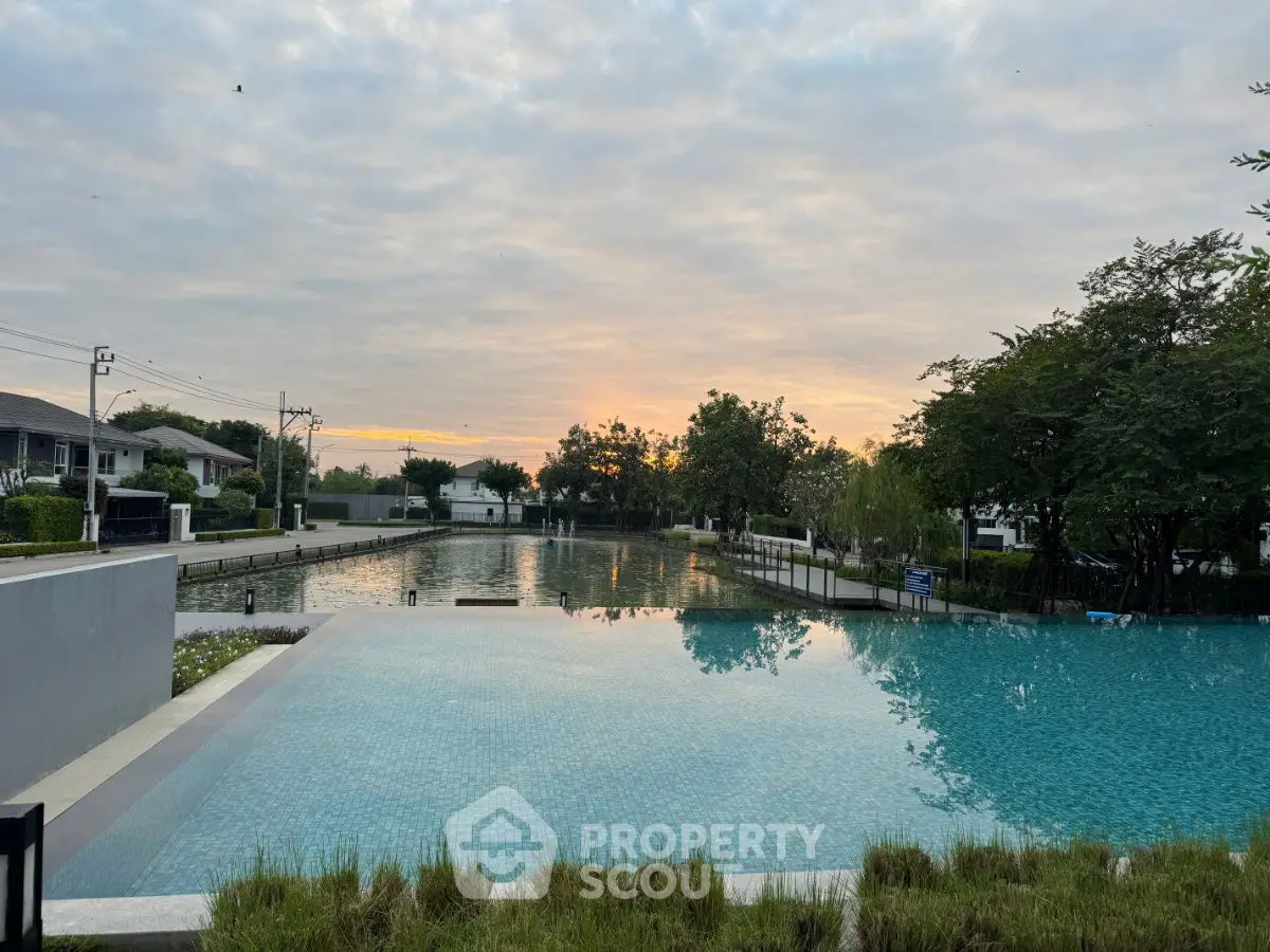 Stunning poolside view at sunrise in a serene residential area.