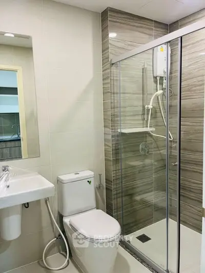 Modern bathroom with glass shower enclosure and sleek fixtures