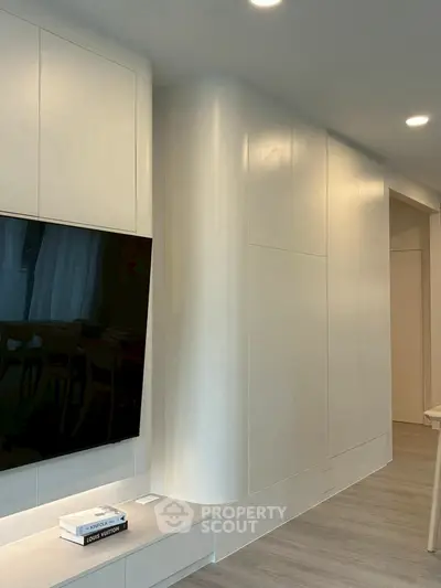 Modern living room with sleek TV setup and stylish cabinetry