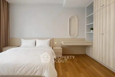 Modern minimalist bedroom with wooden flooring and built-in wardrobe
