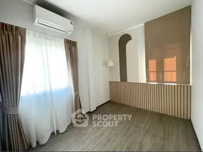 Bright and airy room with modern air conditioning and elegant curtains, perfect for a cozy living space.