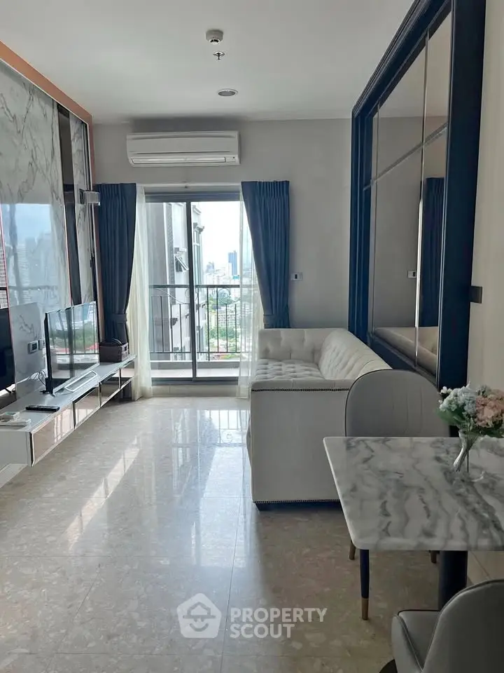 Modern living room with city view, featuring elegant marble flooring and stylish furniture.