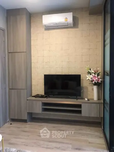 Modern living room with sleek TV unit and air conditioning