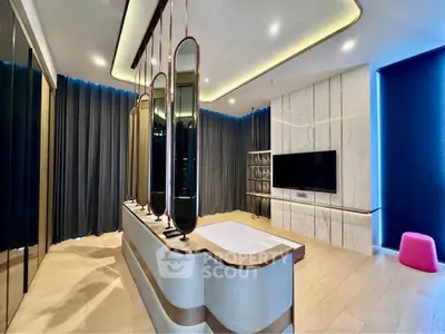 Luxurious modern living room with stylish decor and large TV, perfect for relaxation and entertainment.