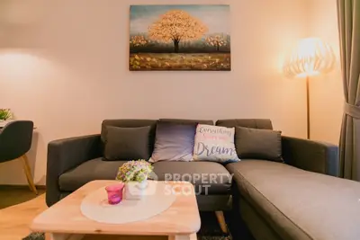 Cozy living room with stylish sofa and warm lighting, perfect for relaxation.