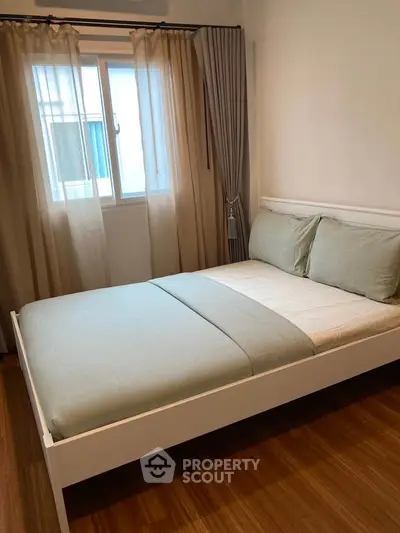 Cozy bedroom with modern decor and natural light from window