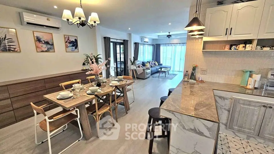 Spacious open-plan living and dining area with modern kitchen and stylish decor