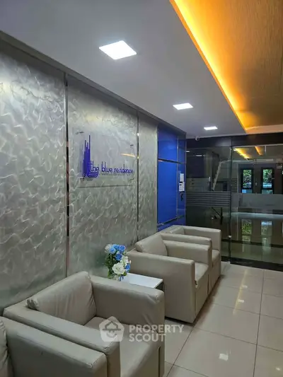 Modern lobby with elegant seating and stylish lighting at The Blue Residence.