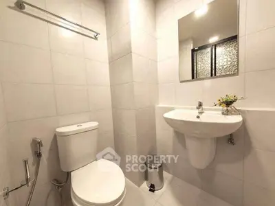Modern bathroom with sleek fixtures and elegant tile design, perfect for a contemporary home.