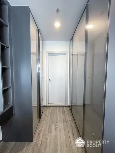 Spacious walk-in closet with sleek modern design and ample storage space.