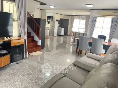 Spacious open-plan living room with modern furniture and sleek design
