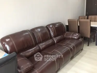 Luxurious leather sofa in modern living room with dining area