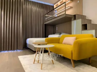 Modern loft-style bedroom with vibrant yellow sofa and cozy ambiance