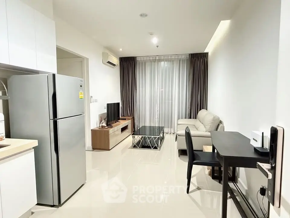 Modern living room with sleek furniture and open kitchen layout in a stylish apartment.