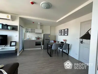 Modern open-plan kitchen and dining area with sleek design and contemporary furnishings.