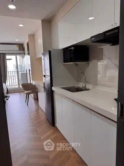 Modern kitchen with sleek cabinets and appliances in a stylish apartment