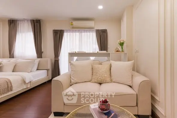 Elegant living room with cozy sofa and stylish decor in modern apartment.