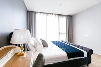 Modern bedroom with elegant decor and large window for natural light