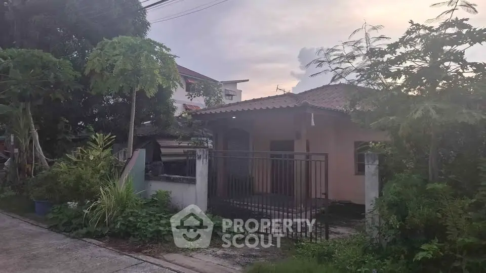 Charming single-story house with lush garden and gated entrance, perfect for serene living.