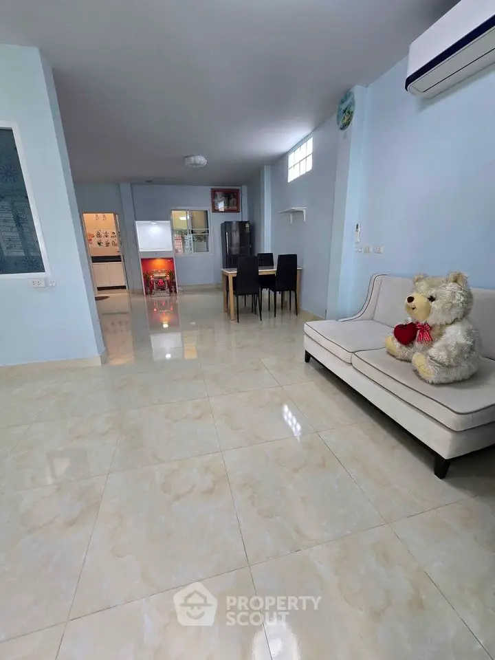 Spacious living room with modern decor and dining area