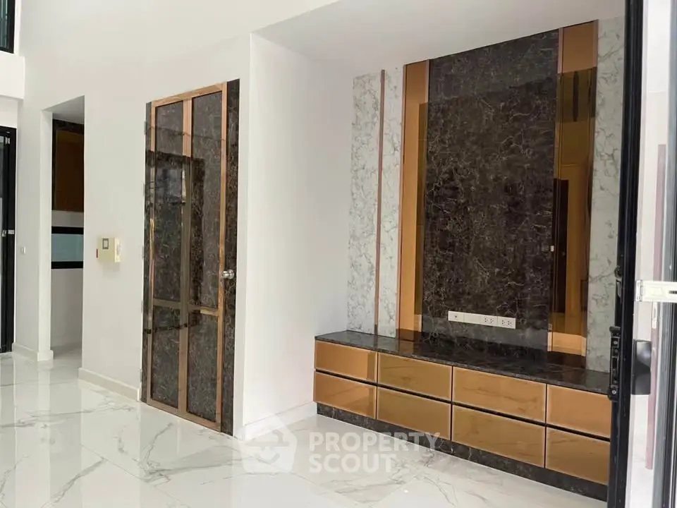 Luxurious modern interior with marble accents and sleek storage solutions.