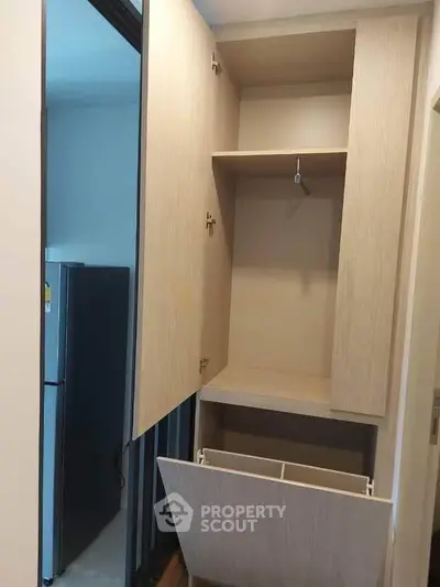 Modern storage cabinet with open doors in a sleek apartment interior
