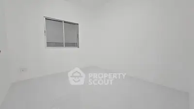 Minimalist empty room with white walls and tiled floor, featuring a single window.