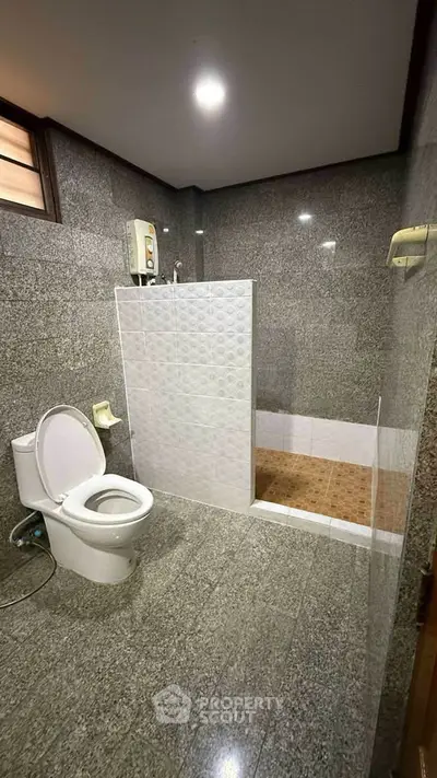 Modern bathroom with sleek gray tiles and walk-in shower