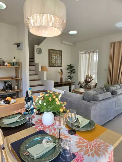 Charming open-plan living and dining area with modern decor and natural light.