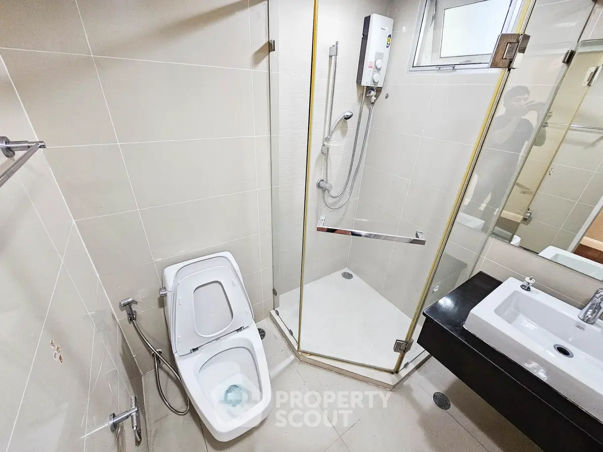 Modern bathroom with glass shower and sleek fixtures