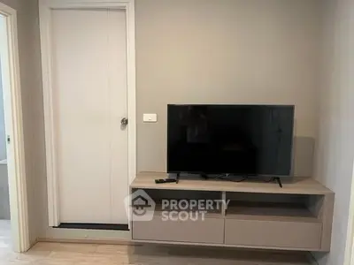 Modern living room with sleek TV stand and flat-screen TV, perfect for cozy entertainment.