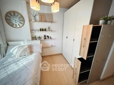 Cozy bedroom with modern decor, featuring a stylish clock and ample storage space.