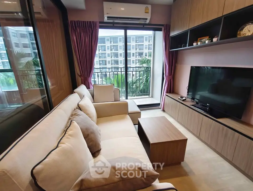 Modern living room with cozy sofa and large window view in stylish apartment