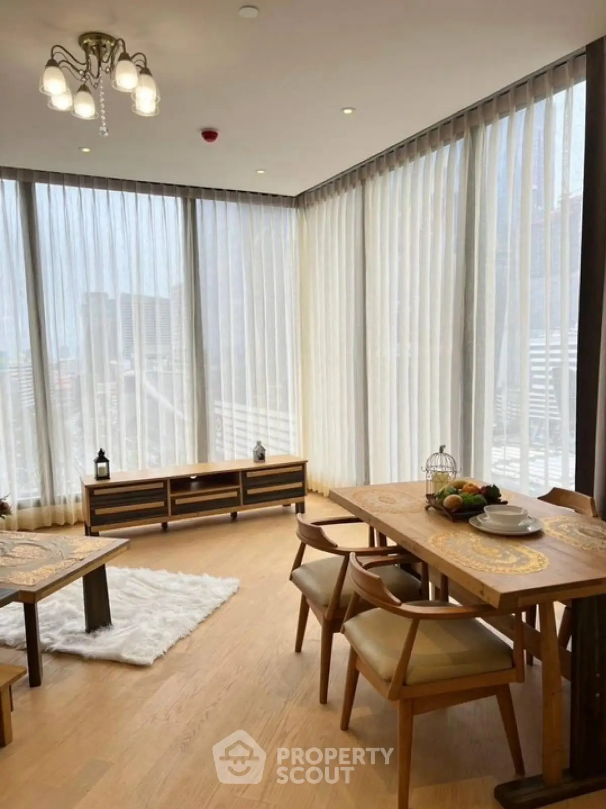 Elegant dining area with large windows and modern furniture, perfect for urban living.