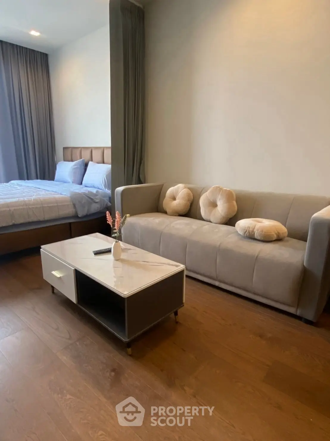 Modern studio apartment with cozy living area and stylish bedroom