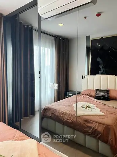 Luxurious bedroom with mirrored wardrobe and elegant decor