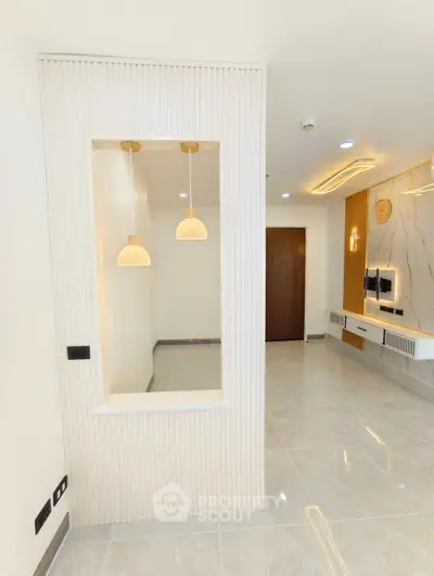 Modern living room with elegant lighting and marble accent wall