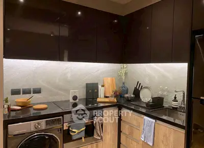 Modern kitchen with sleek cabinets, built-in appliances, and stylish lighting