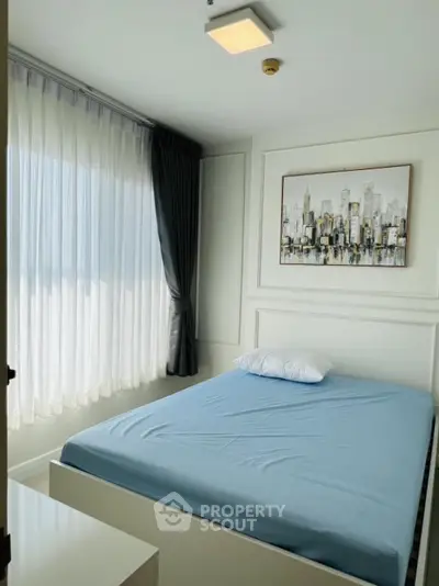 Modern bedroom with cityscape artwork and large window with curtains