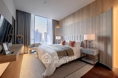 Luxurious bedroom with city view, elegant decor, and modern furnishings in a high-rise apartment.
