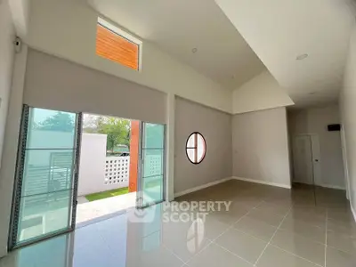 Spacious modern living room with high ceilings and large windows for natural light.