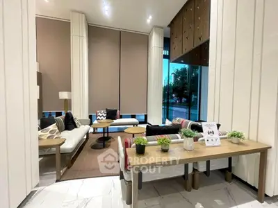 Modern living room with stylish decor and large windows offering natural light.